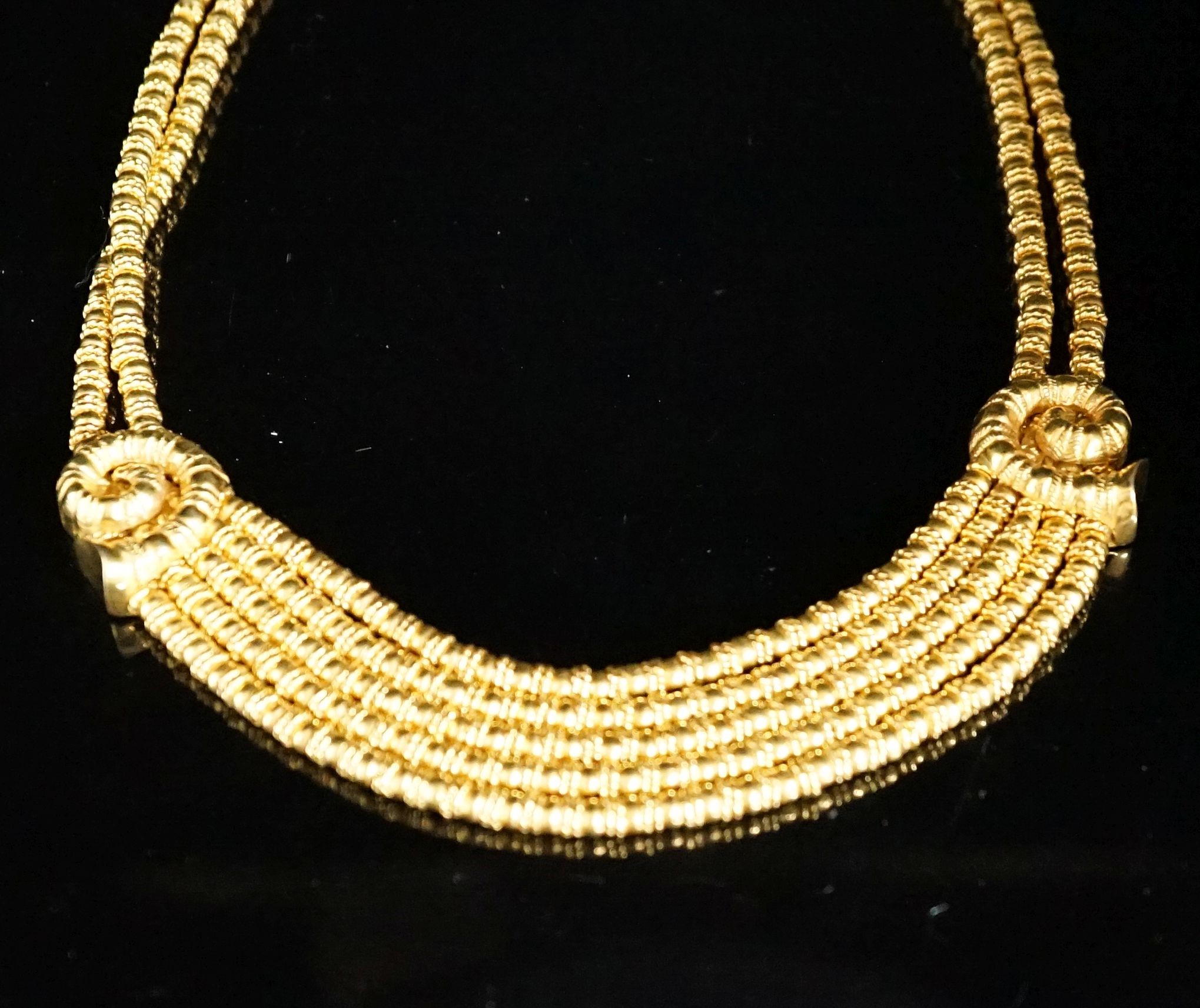 Ilias Lalaounis: a 750 yellow metal multi strand necklace, with shell motifs, 40cm, 146.3 grams, signed.